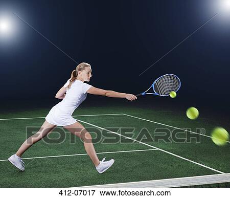 Stock Photo - Multiple exposure of tennis player hitting ball on court. Fotosearch