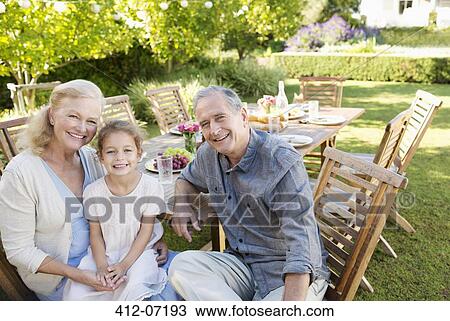 Older couple and granddaughter smiling outdoors View Large Photo Image Stock Image - Older couple and granddaughter smiling outdoors. Fotosearch
