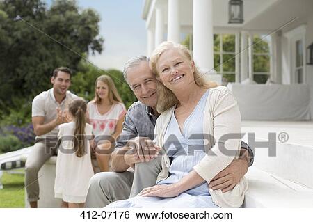 Stock Photograph - Older couple smiling on porch. Fotosearch