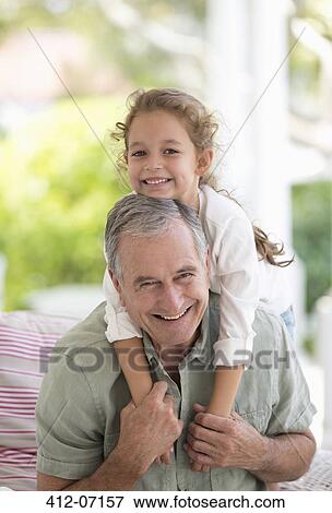 Older man carrying granddaughter piggyback View Large Photo Image Stock Photo - Older man carrying granddaughter piggyback. Fotosearch