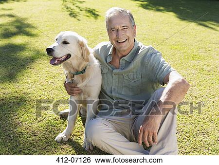 Older man hugging dog in backyard View Large Photo Image Stock Photograph - Older man hugging dog in backyard. Fotosearch