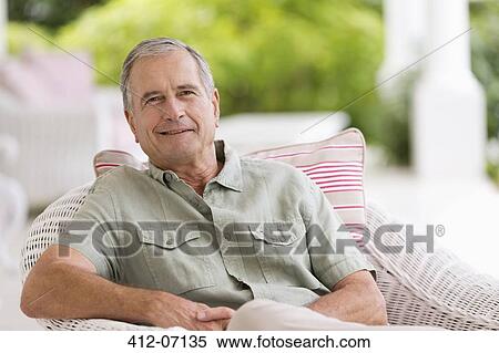Older man sitting in armchair outdoors View Large Photo Image Stock Photography - Older man sitting in armchair outdoors. Fotosearch