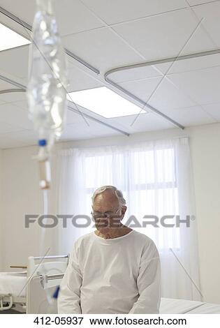 Older patient sitting on bed in hospital room View Large Photo Image Stock Photo - Older patient sitting on bed in hospital room. Fotosearch