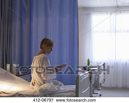Patient using cell phone in hospital bed View Large Photo Image Stock Photo - Patient using cell phone in hospital bed. Fotosearch