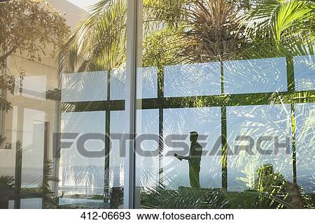 Reflection of businessman in window View Large Photo Image Stock Image - Reflection of businessman in window. Fotosearch