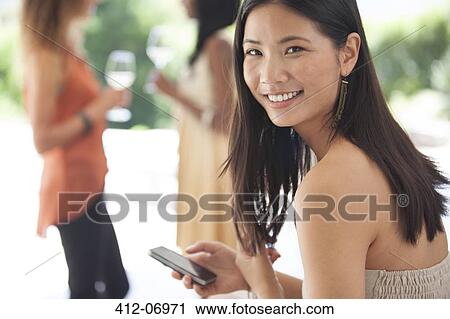 Smiling woman using cell phone View Large Photo Image Stock Image - Smiling woman using cell phone. Fotosearch