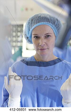 Surgeon standing in operating room View Large Photo Image Stock Image - Surgeon standing in operating room. Fotosearch
