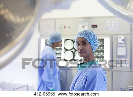 Surgeon standing in operating room View Large Photo Image Stock Photography - Surgeon standing in operating room. Fotosearch