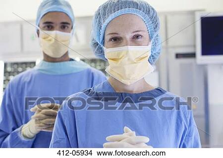 Surgeons standing in operating room View Large Photo Image Picture - Surgeons standing in operating room. Fotosearch