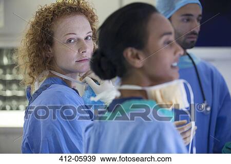 Stock Photo - Surgeons standing in operating room. Fotosearch
