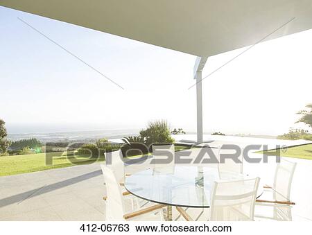 Table and chairs on modern porch View Large Photo Image Stock Image - Table and chairs on modern porch. Fotosearch