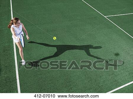 Tennis player casting shadow on court View Large Photo Image Stock Image - Tennis player casting shadow on court. Fotosearch