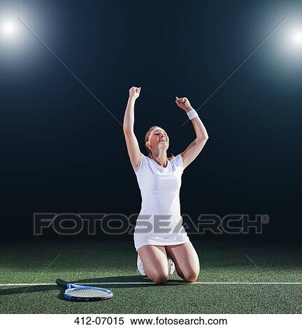 Stock Photography - Tennis player cheering on court. Fotosearch