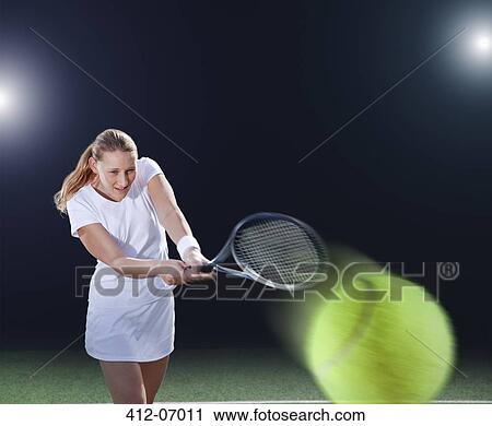 Tennis player hitting ball on court View Large Photo Image Stock Image - Tennis player hitting ball on court. Fotosearch