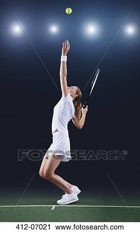Tennis player serving ball on court View Large Photo Image Stock Image - Tennis player serving ball on court. Fotosearch