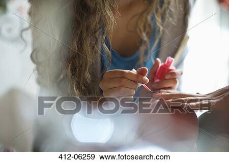 Woman painting friend's nails View Large Photo Image Stock Photo - Woman painting friend's nails. Fotosearch