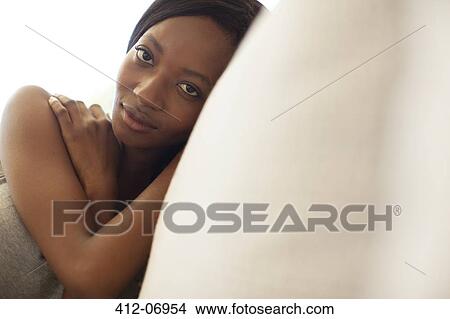 Woman relaxing on sofa View Large Photo Image Picture - Woman relaxing on sofa. Fotosearch