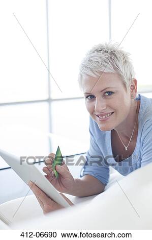 Woman shopping online with tablet computer View Large Photo Image Stock Image - Woman shopping online with tablet computer. Fotosearch
