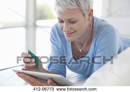 Woman shopping online with tablet computer View Large Photo Image Stock Image - Woman shopping online with tablet computer. Fotosearch