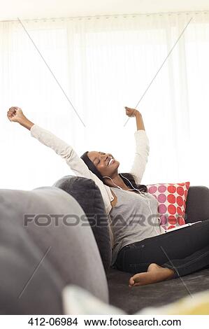 Woman stretching on sofa View Large Photo Image Picture - Woman stretching on sofa. Fotosearch