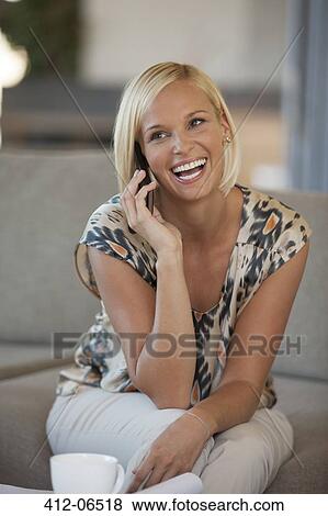 Woman talking on cell phone on sofa View Large Photo Image Stock Photo - Woman talking on cell phone on sofa. Fotosearch