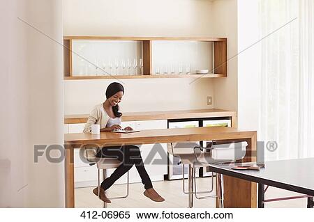Woman using tablet computer at table View Large Photo Image Stock Photography - Woman using tablet computer at table. Fotosearch
