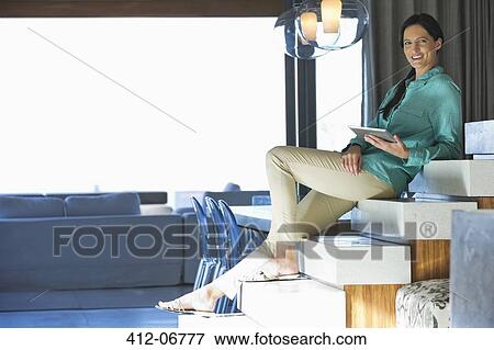 Woman using tablet computer on steps View Large Photo Image Stock Photo - Woman using tablet computer on steps. Fotosearch
