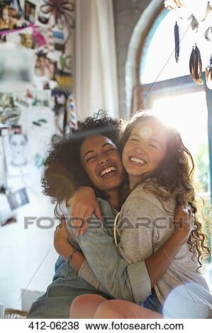 Women hugging in bedroom View Large Photo Image Stock Photo - Women hugging in bedroom. Fotosearch