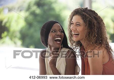 Women laughing together outdoors View Large Photo Image Stock Image - Women laughing together outdoors. Fotosearch