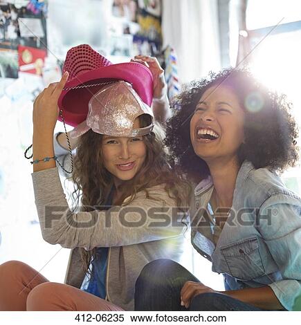 Women playing with hats in bedroom View Large Photo Image Stock Photography - Women playing with hats in bedroom. Fotosearch