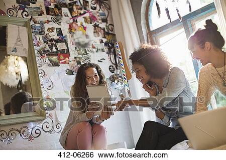 Women relaxing together in bedroom View Large Photo Image Stock Photograph - Women relaxing together in bedroom. Fotosearch