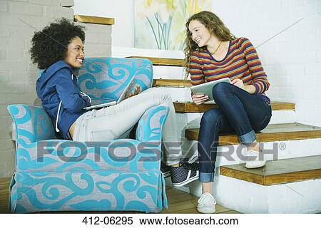 Stock Photography - Women relaxing together on steps. Fotosearch
