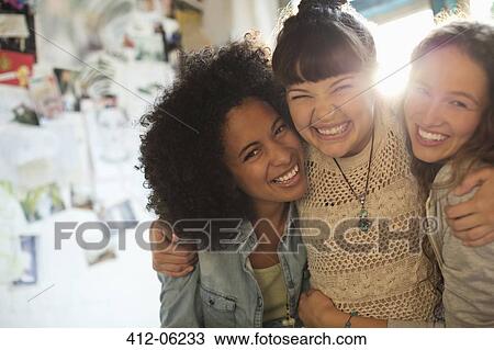 Stock Image - Women smiling together indoors. Fotosearch