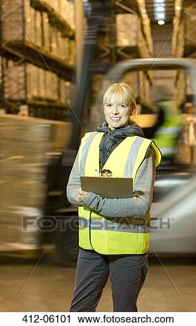 Worker holding clipboard in warehouse View Large Photo Image Stock Image - Worker holding clipboard in warehouse. Fotosearch