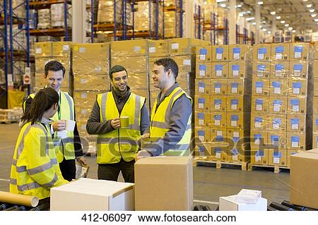 Stock Photo - Workers drinking coffee in warehouse. Fotosearch