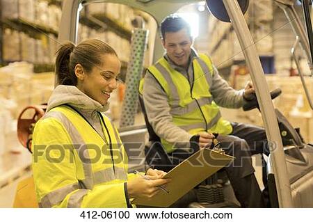 Workers talking in warehouse View Large Photo Image Stock Image - Workers talking in warehouse. Fotosearch