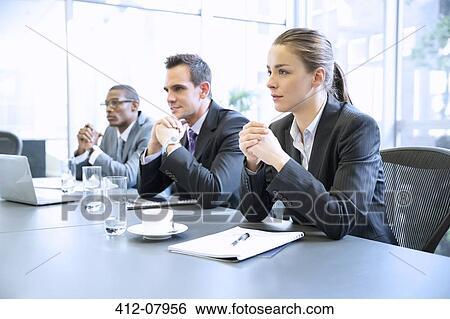 Attentive business people with hands clasped in meeting View Large Photo Image Stock Photograph - Attentive business people with hands clasped in meeting. Fotosearch