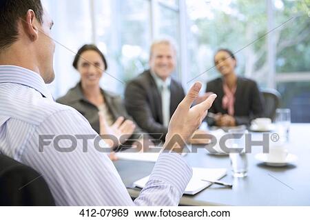 Businessman gesturing in meeting View Large Photo Image Stock Photo - Businessman gesturing in meeting. Fotosearch