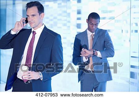 Stock Image - Businessmen in lobby. Fotosearch
