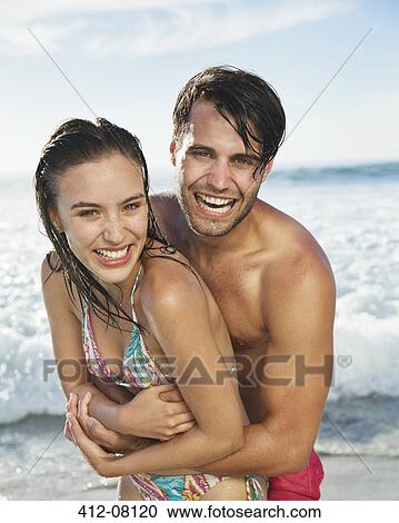 Close up portrait of happy couple hugging on beach View Large Photo Image Stock Image - Close up portrait of happy couple hugging on beach. Fotosearch