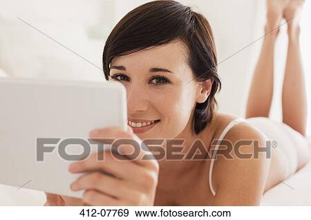 Close up portrait of smiling woman using digital tablet View Large Photo Image Stock Photo - Close up portrait of smiling woman using digital tablet. Fotosearch