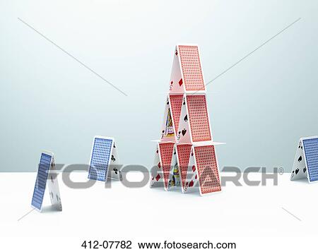 Contrasting, small houses of cards surrounding large house of cards View Large Photo Image Stock Image - Contrasting, small houses of cards surrounding large house of cards. Fotosearch