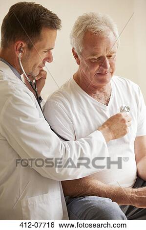 Doctor checking senior man's heart with stethoscope View Large Photo Image Stock Photograph - Doctor checking senior man's heart with stethoscope. Fotosearch