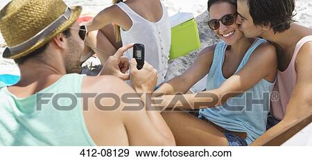 Friends hanging out at beach View Large Photo Image Stock Photo - Friends hanging out at beach. Fotosearch