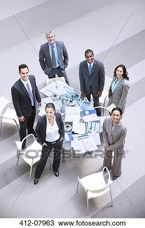 High angle portrait of smiling business people at table View Large Photo Image Stock Image - High angle portrait of smiling business people at table. Fotosearch