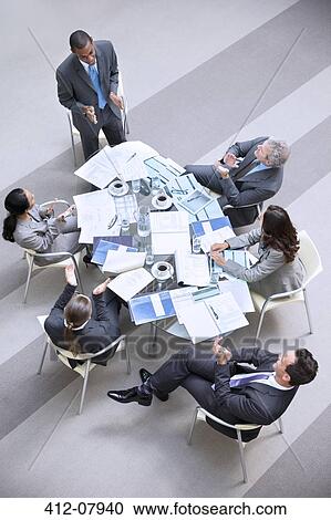 High angle view of businessman leading meeting View Large Photo Image Stock Image - High angle view of businessman leading meeting. Fotosearch