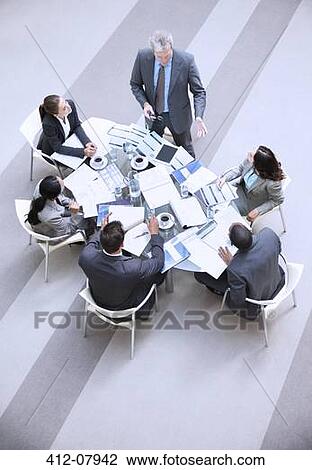 High angle view of businessman leading meeting View Large Photo Image Stock Image - High angle view of businessman leading meeting. Fotosearch