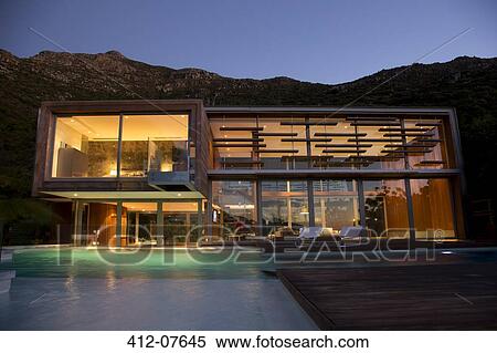 Stock Photography - Illuminated modern house at night. Fotosearch