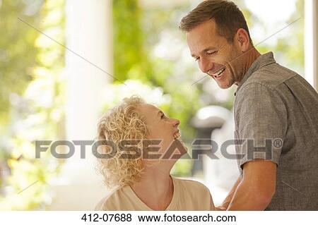 Laughing couple on patio View Large Photo Image Stock Photo - Laughing couple on patio. Fotosearch