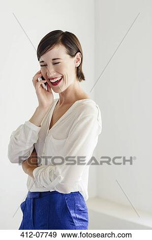 Laughing woman talking on cell phone View Large Photo Image Stock Photo - Laughing woman talking on cell phone. Fotosearch